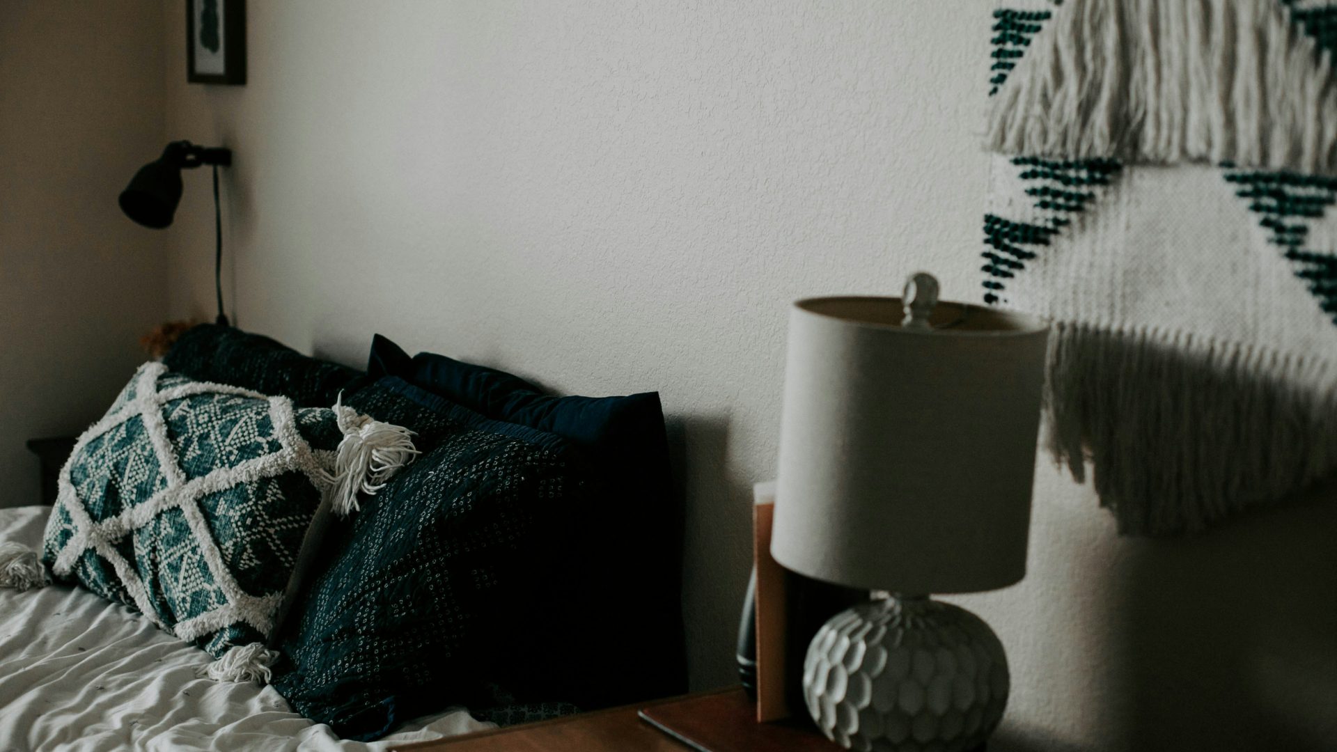 white table lamp on wooden side table