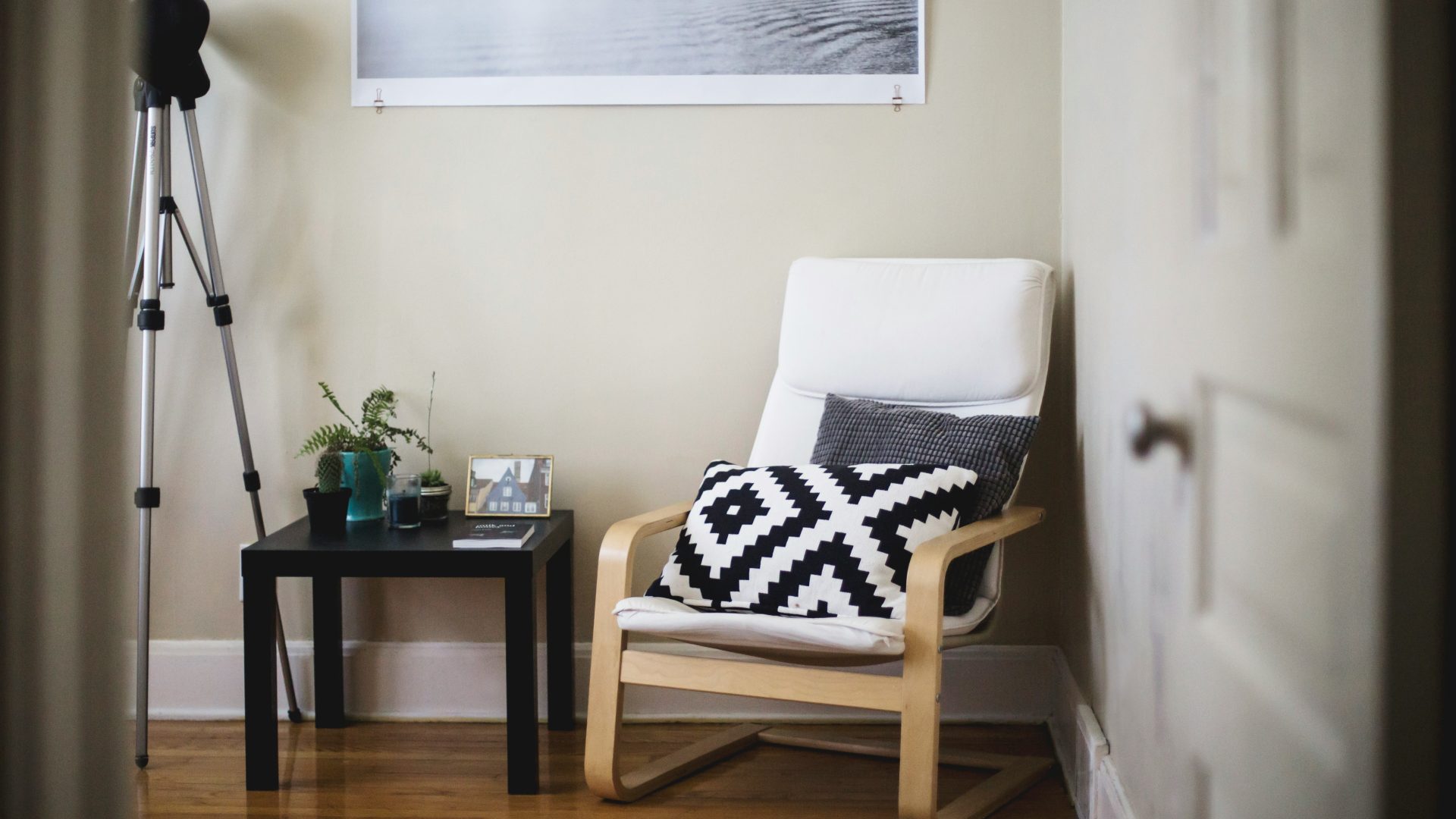 throw pillow on chair beside end table inside room