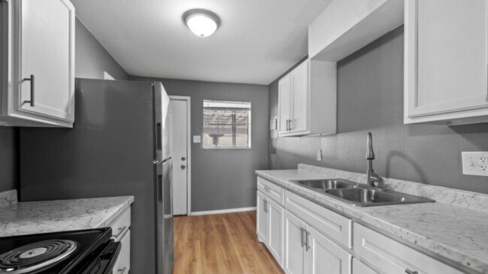 a black and white photo of a kitchen at The Arden Arms Apartments