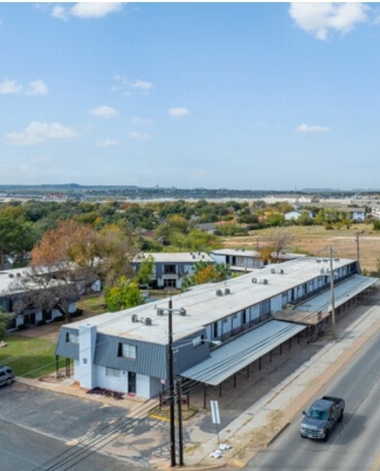 an aerial view of a street with cars and buildings at The Arden Arms Apartments